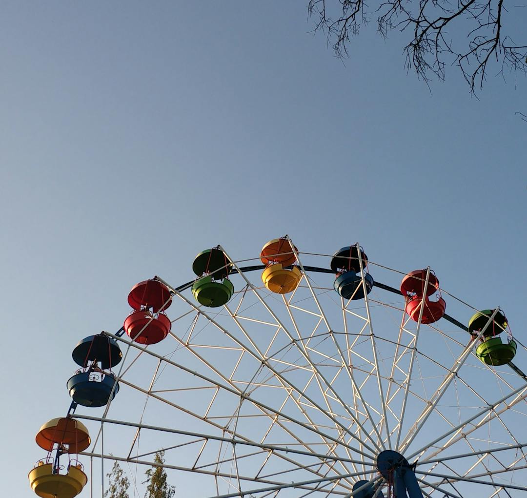 A colorful ferris wheel against a clear sky.